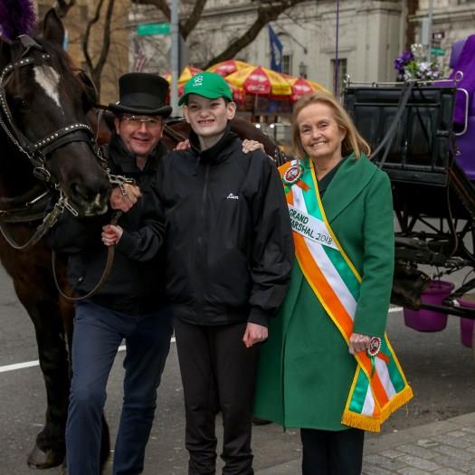 Loretta Brennan Glucksman (far right) rode alongside grandson Liam (right) as grand marshal in the St. Patrick's Day parade.