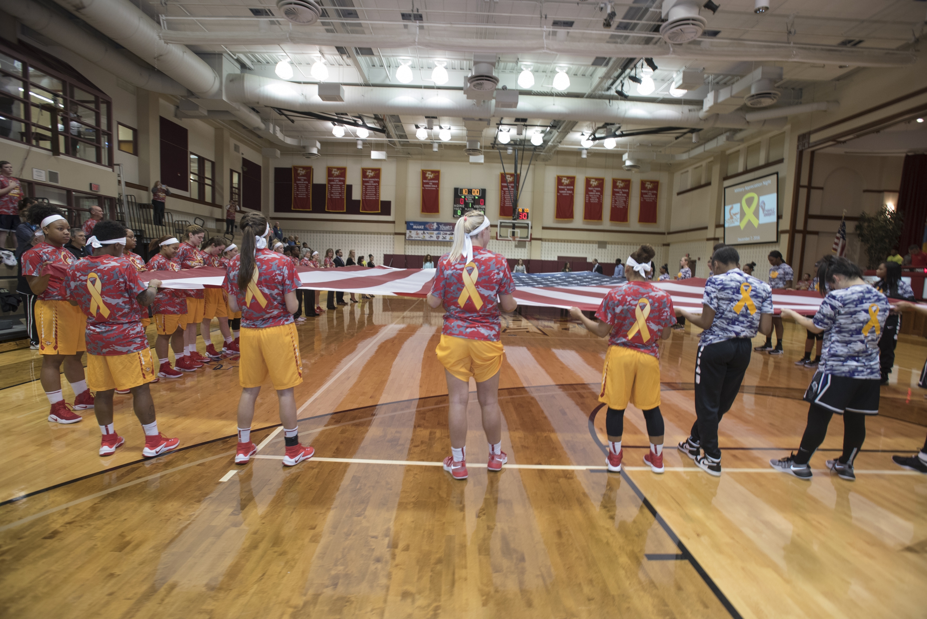 Prior to the game, members of both teams wore camouflage warm-ups and rolled out a court-sized American flag, donated by Metropolitan Flag & Banner.