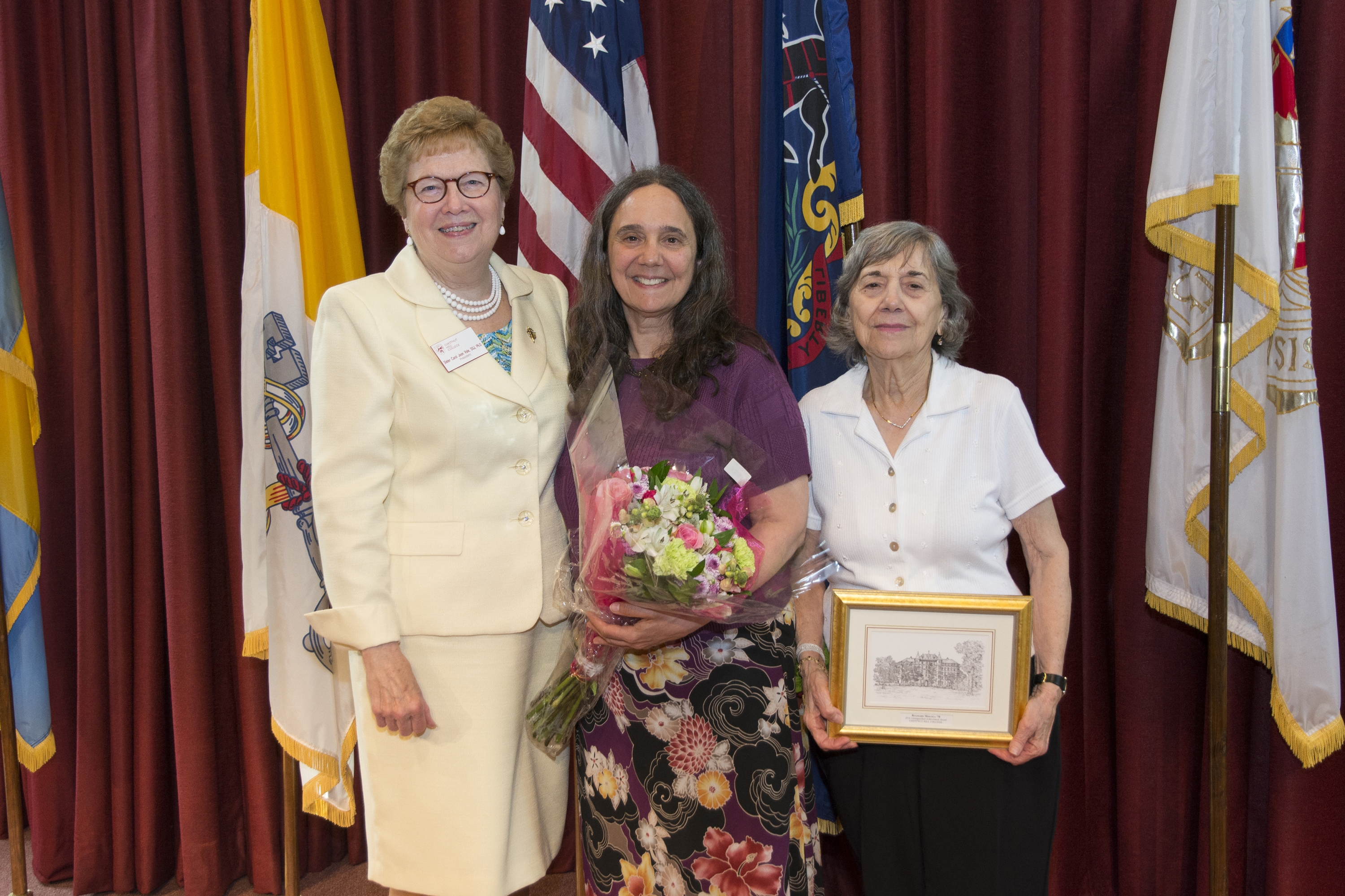 Ritamarie Moscola M.D., M.P.H. '78, center, and her mother pose with Sister Carol after the ceremony.