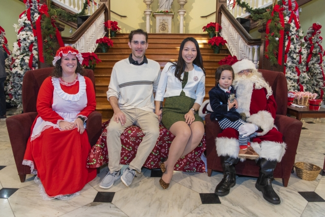 The Youngman family taking photos with Santa and Mrs. Claus during Breakfast with Santa.