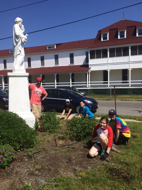 Students clean up the grounds of St. Mary's by the Sea.
