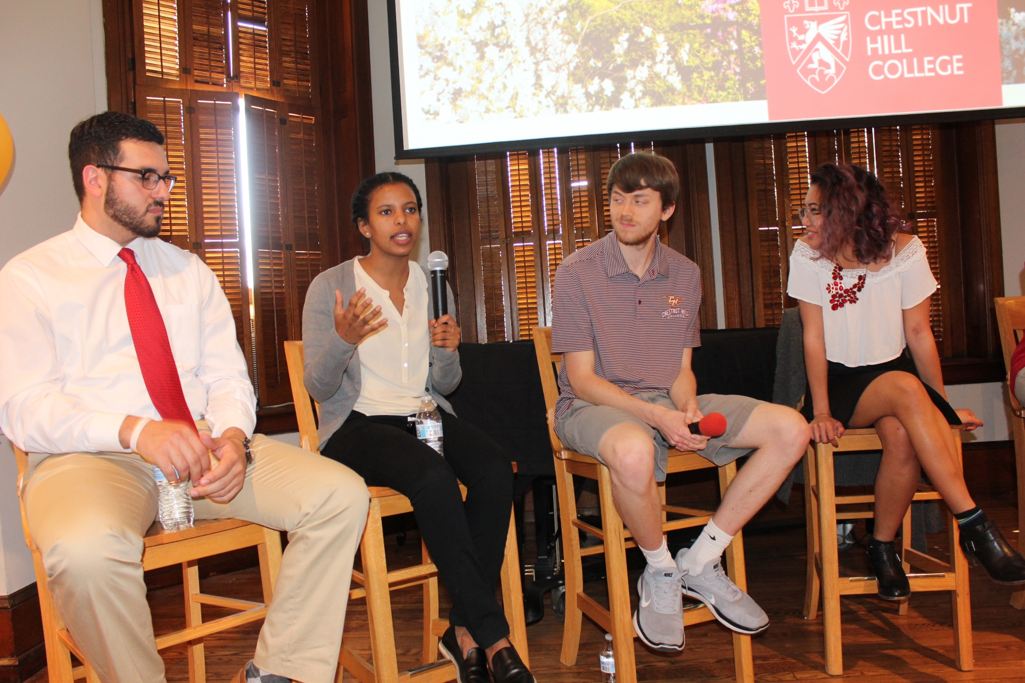 Members of the student panel, Kristian Hernandez (far left), Andrew Conboy (right) and Jaida Zabala (far right) listen intently as Liz Legesse (left) shares her experiences with studying abroad.