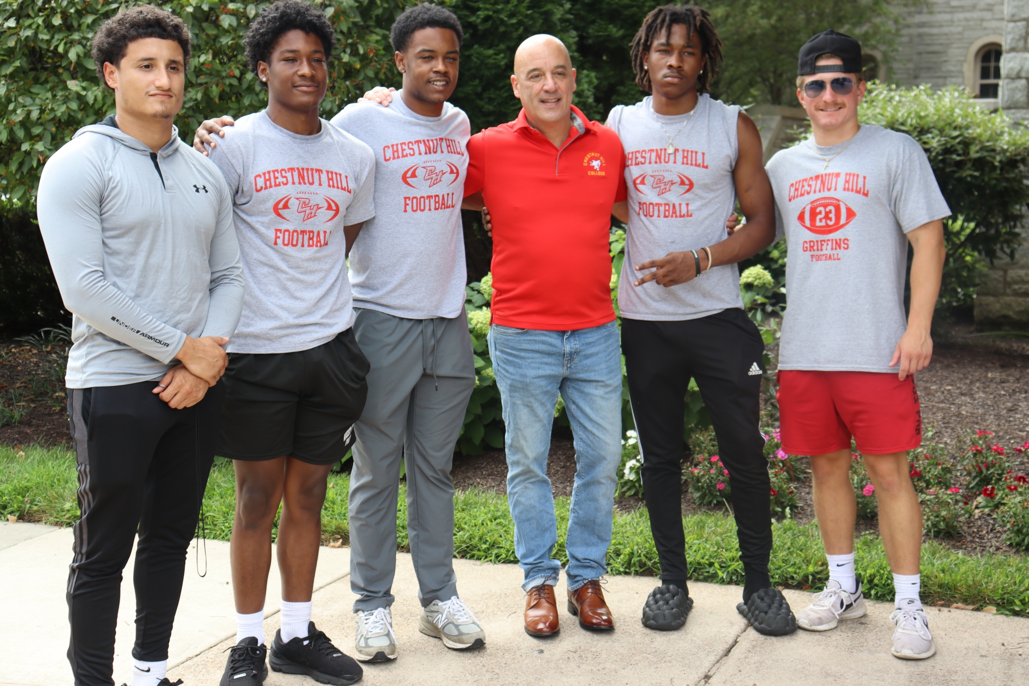 Dr. Latimer poses for a photo with members of the sprint football team during this year's move-in.