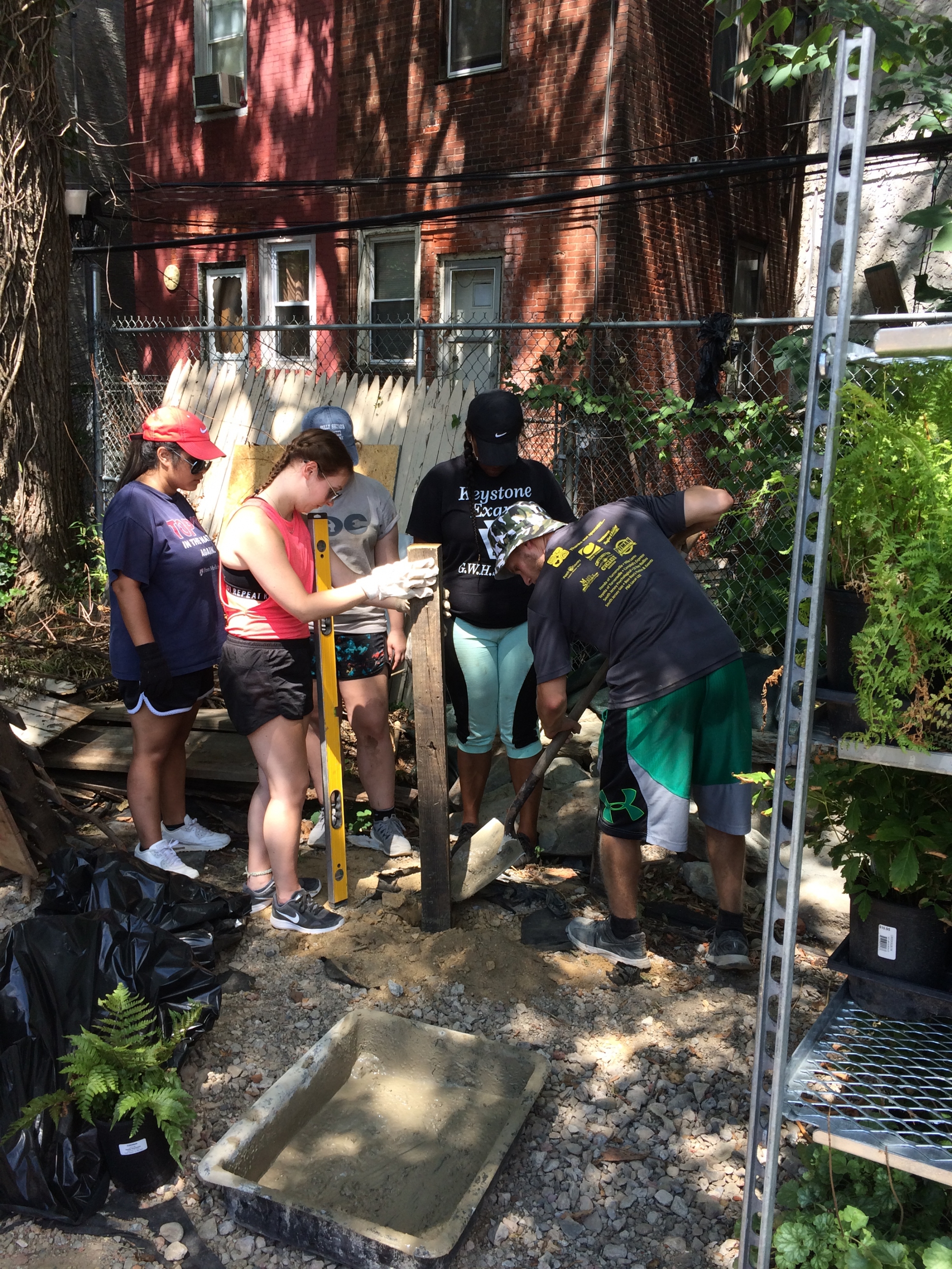 LENS students move plants and make repairs at Greensgrow West Urban Farm.