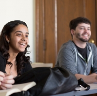 Male and Female student smiling in class
