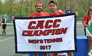 Graduating seniors, Jonathan Ducretot and Pedro Oranges, pose with the championship banner, which now hangs in the rafters of Sorgenti Arena.