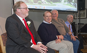Walter Childs, M.B.A., smiles as his faculty colleagues try to correctly answer questions about him.