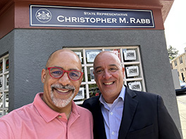 Representative Chris Rabb and Dr. William Latimer pose for a photo outside of Rabb's office.