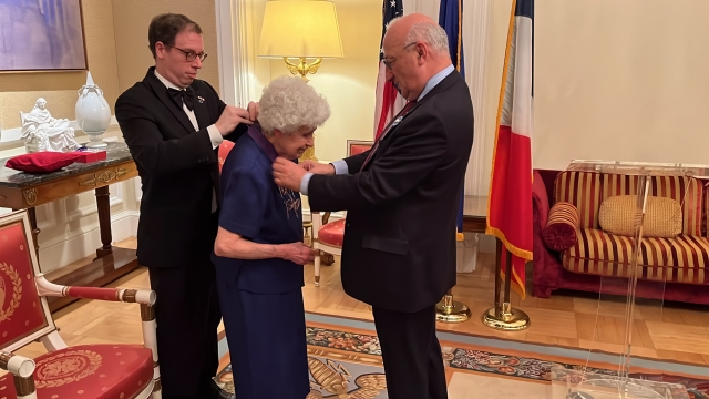Sister Mary Helen receiving the Palmes Académiques Award from Ambassador Étienne.