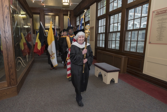 Sister Mary Helen Kashuba leads graduate processional through the Hall of Philanthropy.