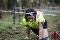 Layla Cruz '17 makes her way through the Barbed Wire Crawl portion of the race.