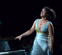 Chin-Yun standing next to a piano 