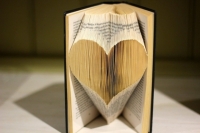 Heart shape made from folded pages of book still in book