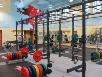 New equipment on the weight room floor of the re-designed fitness center adds color and functionality.