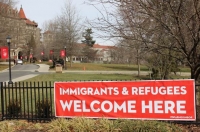 Banner saying "immigrants and refugees welcome here"