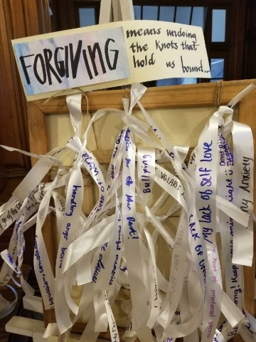 Pieces of paper with words of forgiveness written on them