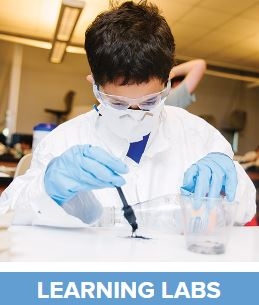 Child in lab gear doing chemistry with text 'Learning labs'