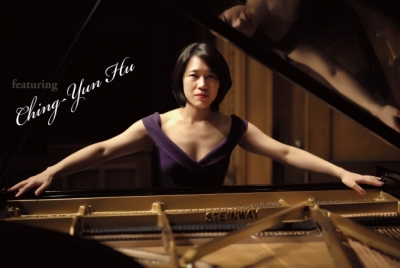 Ching-Yun Hu sitting at a piano