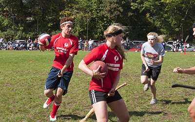Quidditch players running with ball