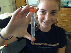A kid holding a test tube