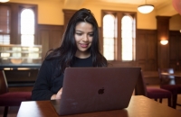 female student on laptop in lounge