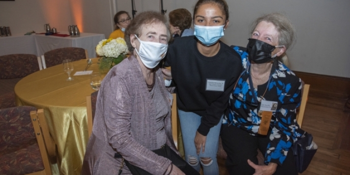 three women with masks smiling