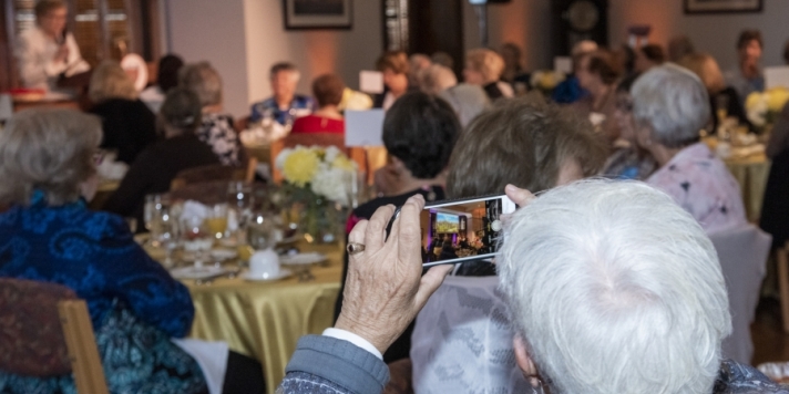 woman taking a photo during presentation
