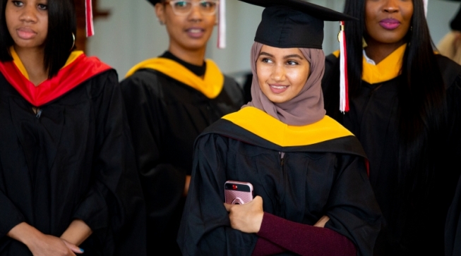 Students in caps and gowns at graduation ceremony