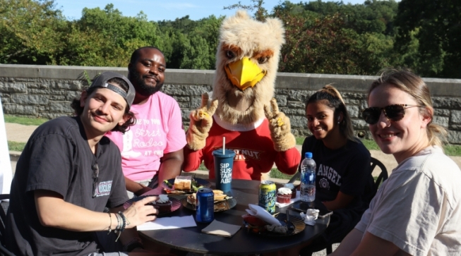 students and mascot outside campus