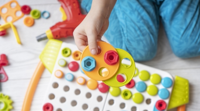 child playing with a colorful puzzle