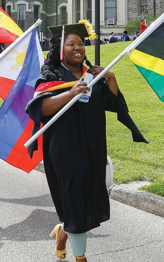 students carrying flags at commencement ceremony