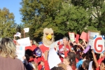 group of kids gathered outside with college mascot