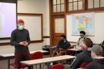 student displays app in classroom with other students