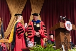 Cathy Lockyer Moulton, Chair of the Chestnut Hill College Board of Directors, places the Presidential Medal around William Latimer's neck, completing his investiture as the seventh president of Chestnut Hill College.