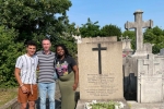 Students and faculty stand outside gravestone during visit to France