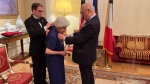 Sister Mary Helen receiving the Palmes Académiques Award from Ambassador Étienne