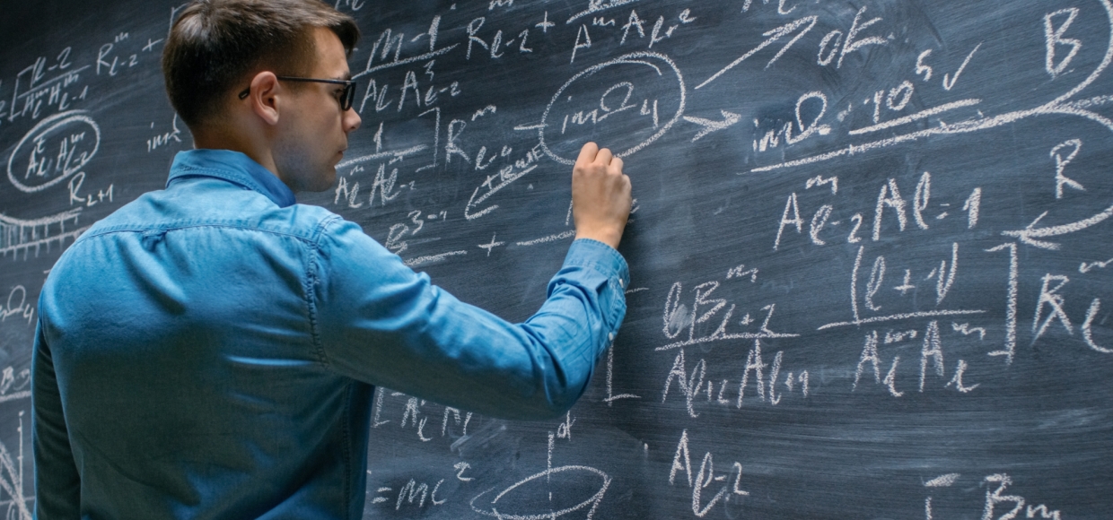 Person doing complex math on chalkboard