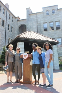 Sister Carol Jean Vale (left) and Sister Joannie Cassidy (2nd to right) stand with students following the blessing of the Clement Hall renovations, which are set to begin following Commencement.