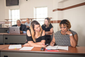 group of adult students learning together in a classroom