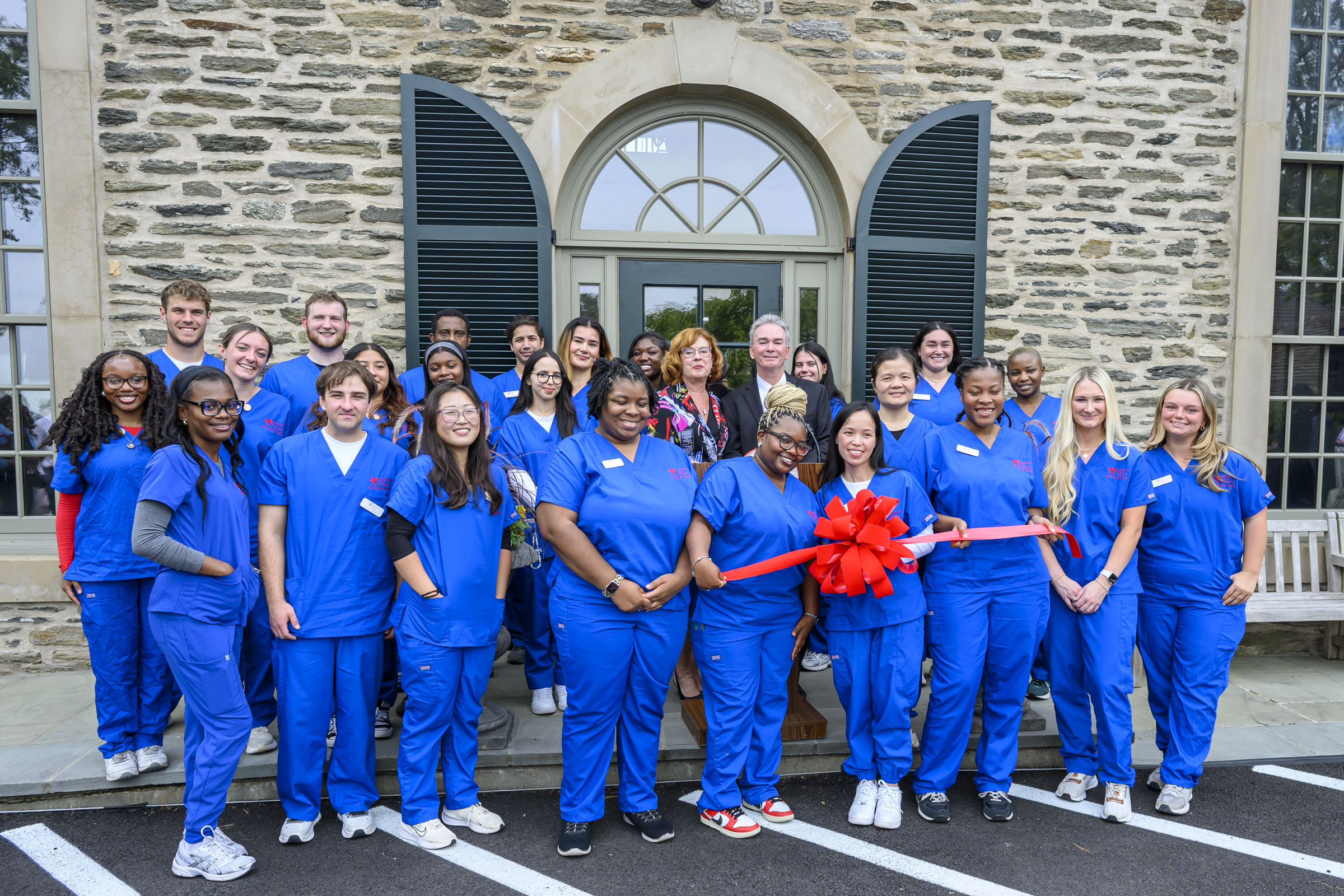 group of nursing students prepare to break wall during groundbreaking