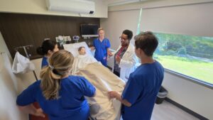CHC nursing students working with a clinical mannequin