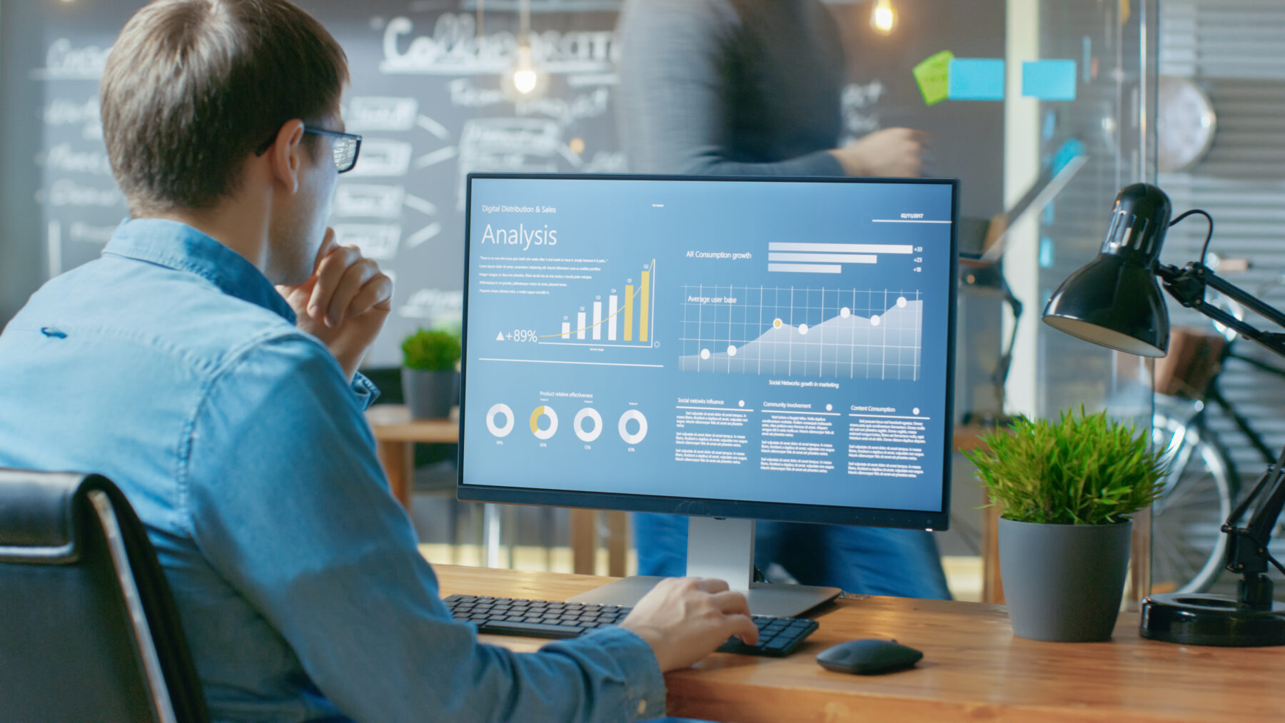 male analyst working on data and statistics in a home office setting